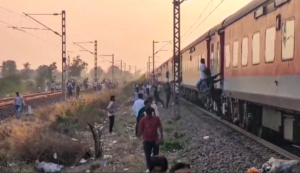 Train accident kills 12 in western India after passengers jump onto tracks over fire alert