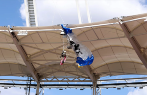 Rugby game delayed after parachutist dangles from the stadium roof prior to kickoff
