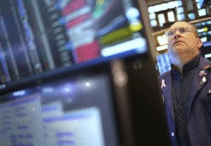 US stocks sink after a weak report on the economy but then halve their losses after inflation update